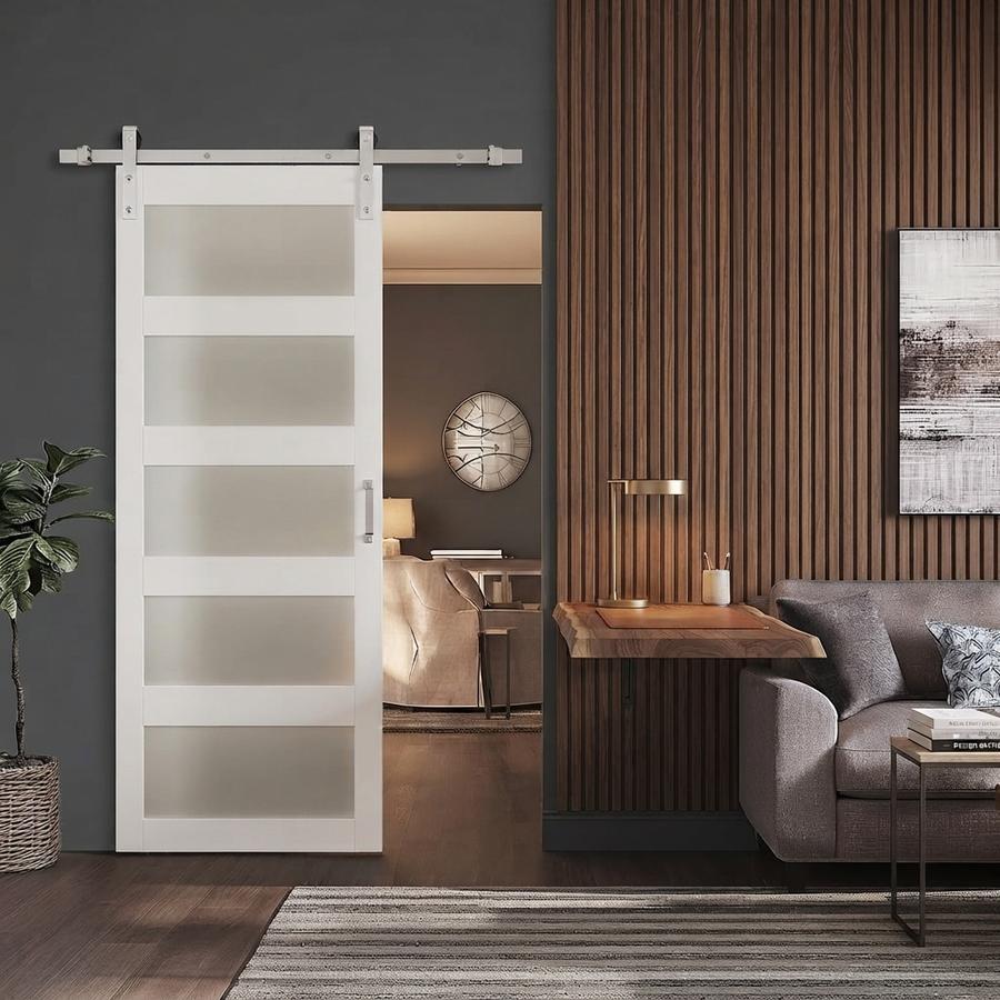 Glass barn door hung on a brushed nickel rail above a kitchen doorway
