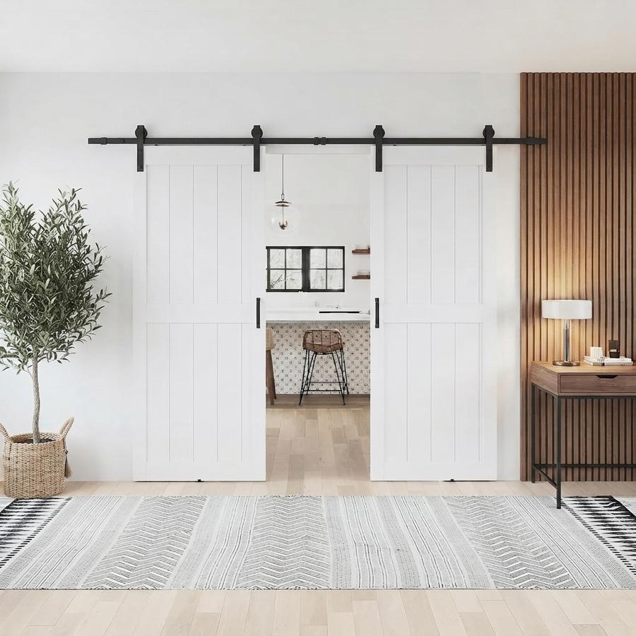 White double barn doors closed across a wide pantry alcove